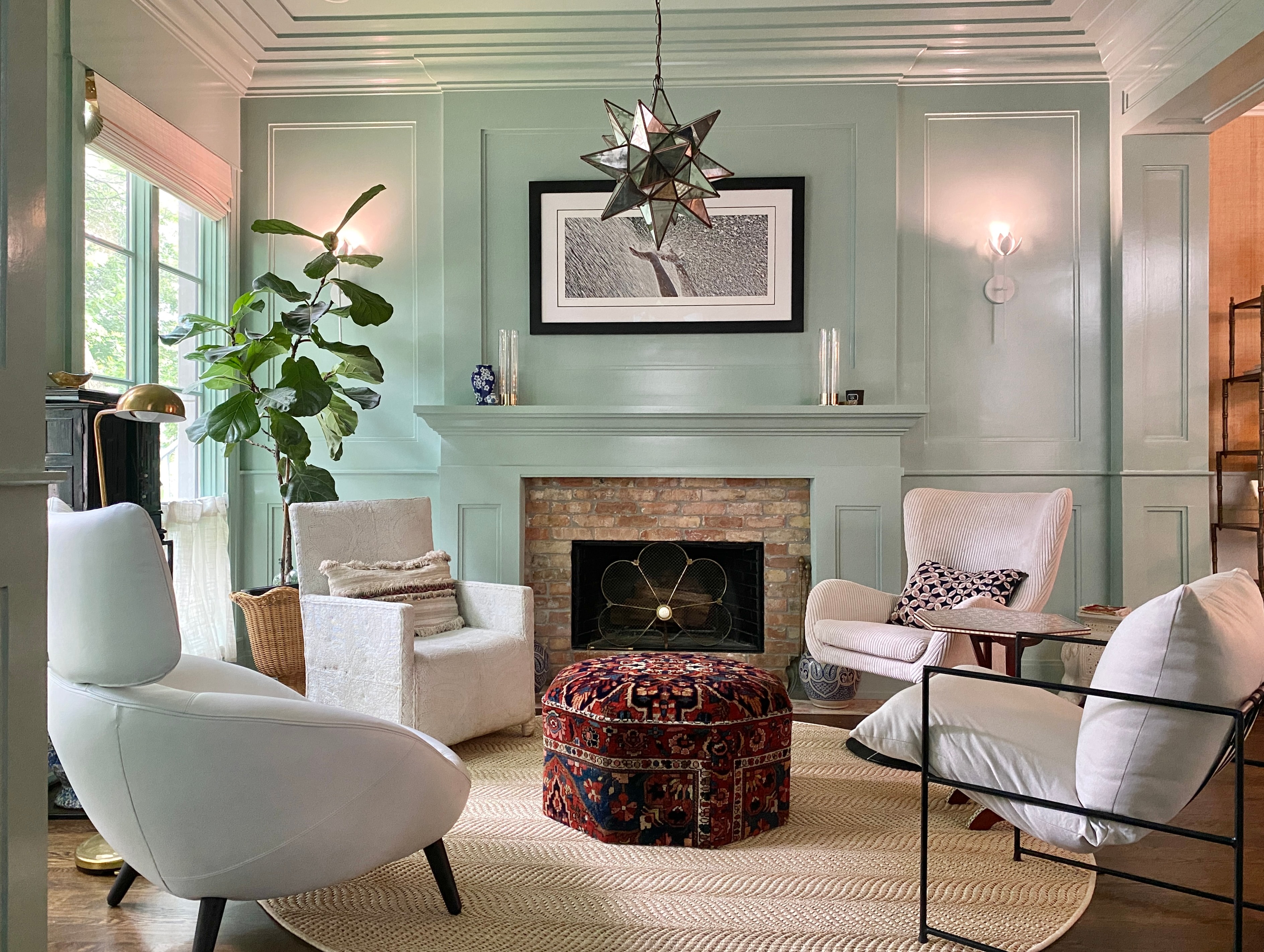 A warm, inviting living room with mint green walls and fireplace